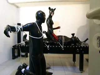 Three Latex Cats Tie Up Their Submissive Slave